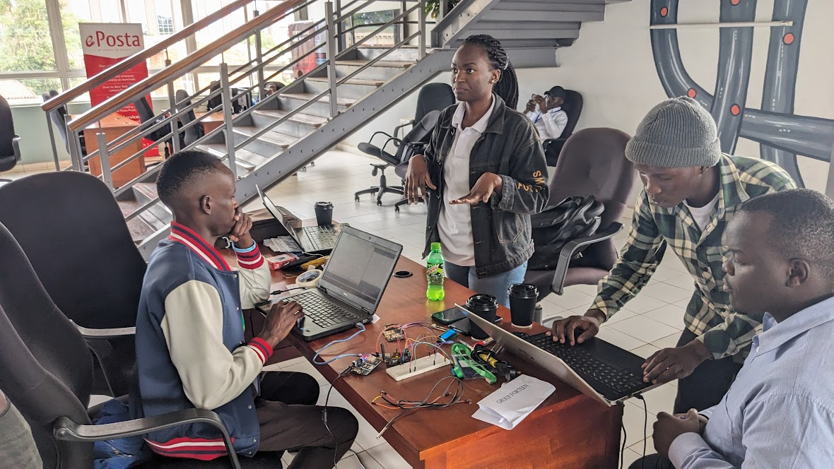 A multi-disciplinary team collaborating on building their prototype using resources at their disposal.